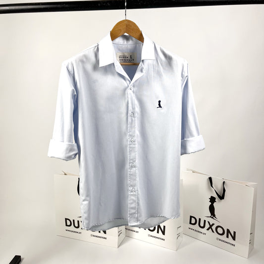 CAMISA Oxford Clasica en celeste con logo en azul marino.